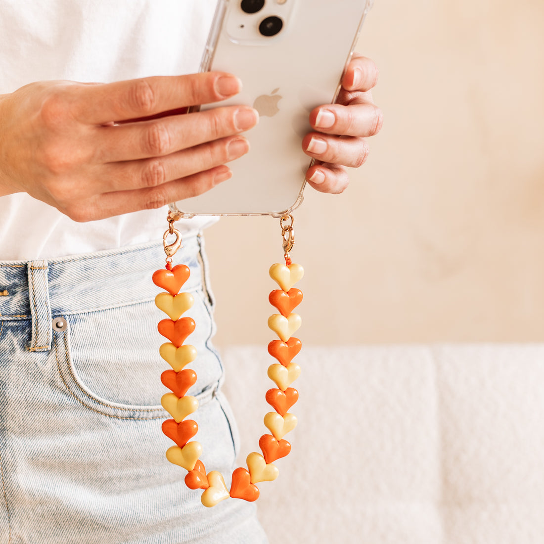 Phone case with orange &amp; yellow hearts cord